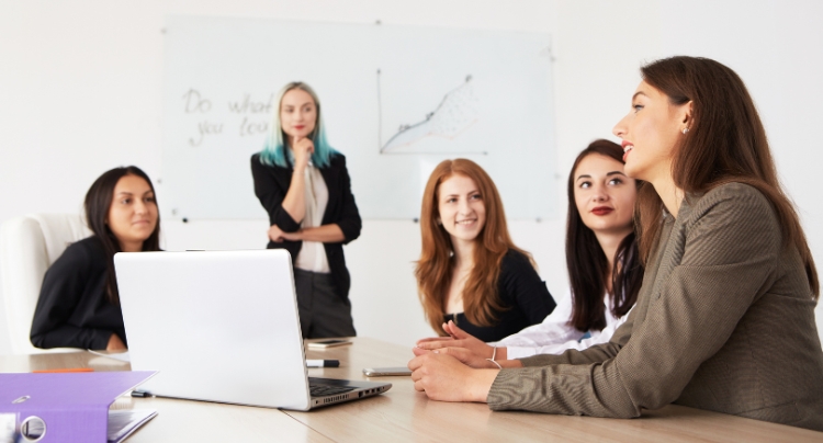 Employees collaborating on a project in a modern open office space
